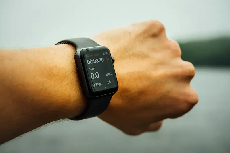 Close-up of a smartwatch tracking activity on a wrist, illustrating the Vitality Apple Watch benefit and fitness tracking rewards